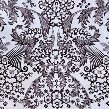 Black and white floral and leaf pattern on a textured fabric background