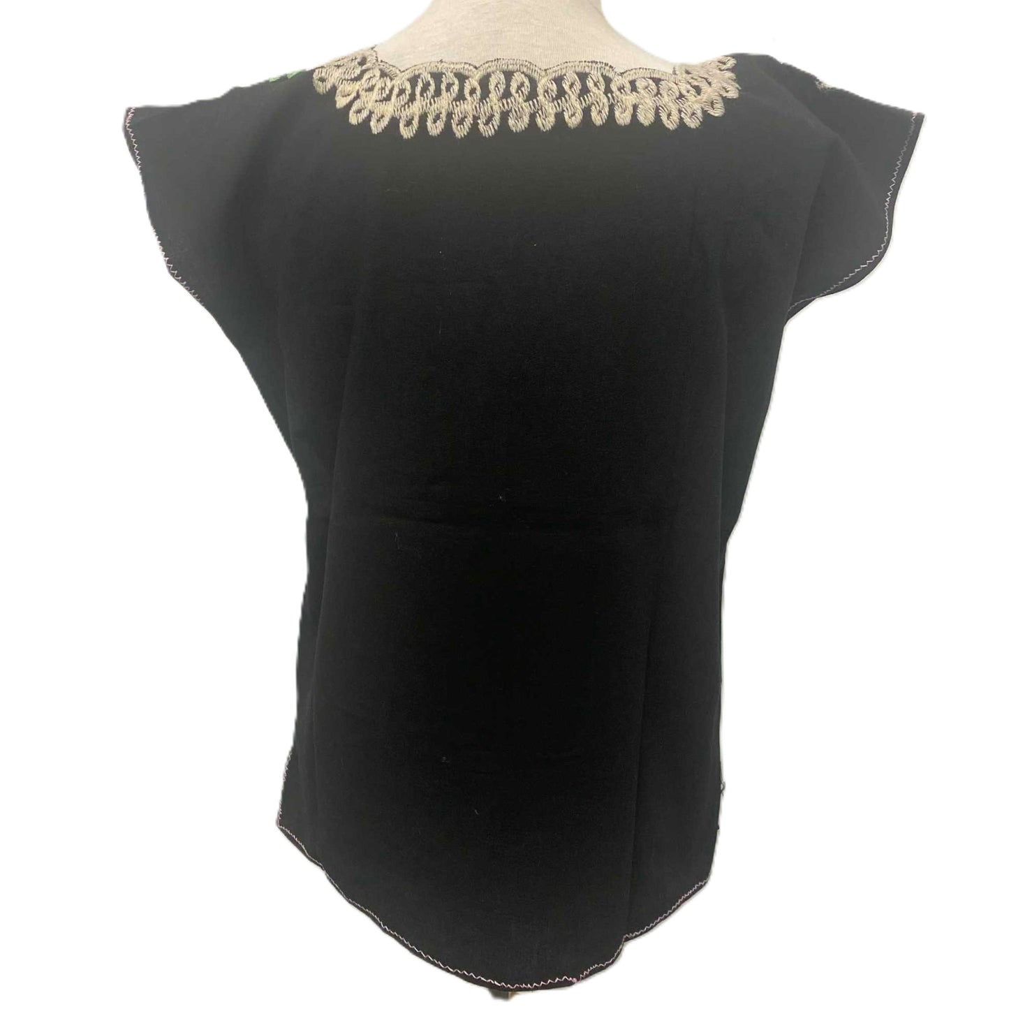 Black top with gold lace neckline on a mannequin against a white background
