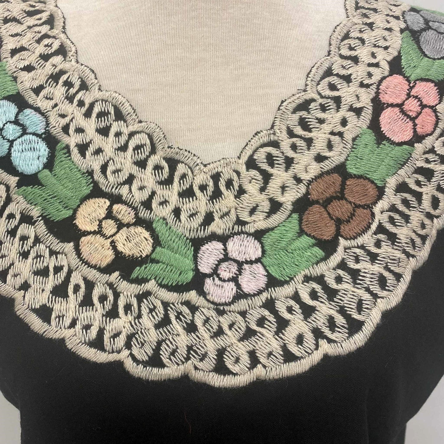Close-up of embroidered floral collar on a garment