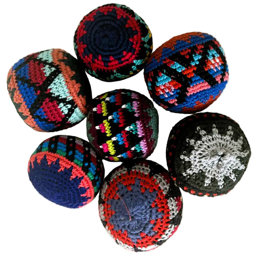 Colorful crocheted balls on a wooden surface